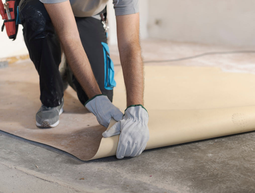 Man carefully undertaking vinyl floor removal